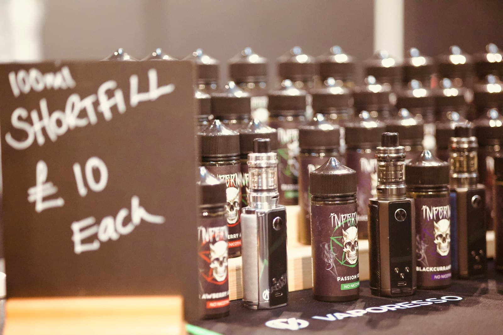 Several small e-liquid bottles lined up together on a table